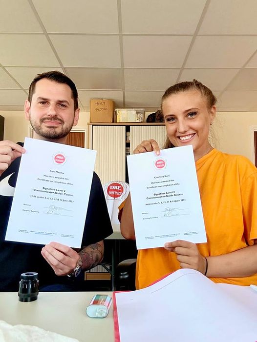 Sam and Courtney holding their certificates